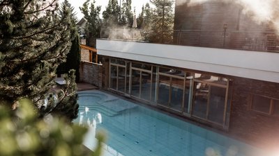 The best photos from our hotel in South Tyrol that kids love View of an empty heated outdoor pool next to a modern building
