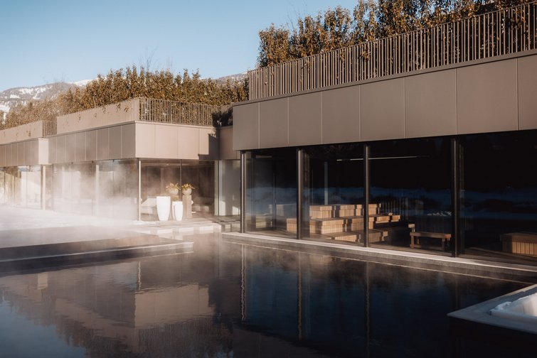The multi-faceted Sonnenspa at our spa hotel in South Tyrol Modern spa area with steam bath and hot outdoor pool in winter mountains