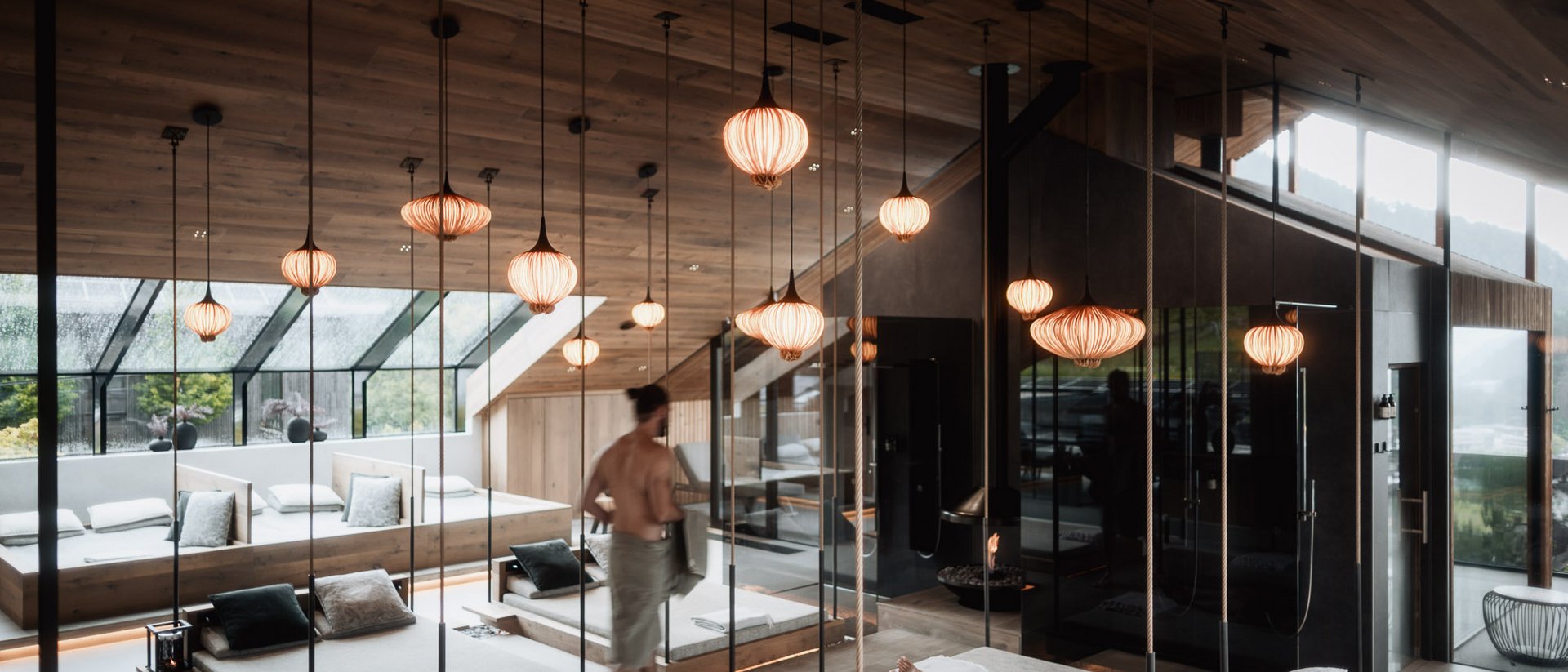 Modern spa lounge with hanging lamps and relaxing guests