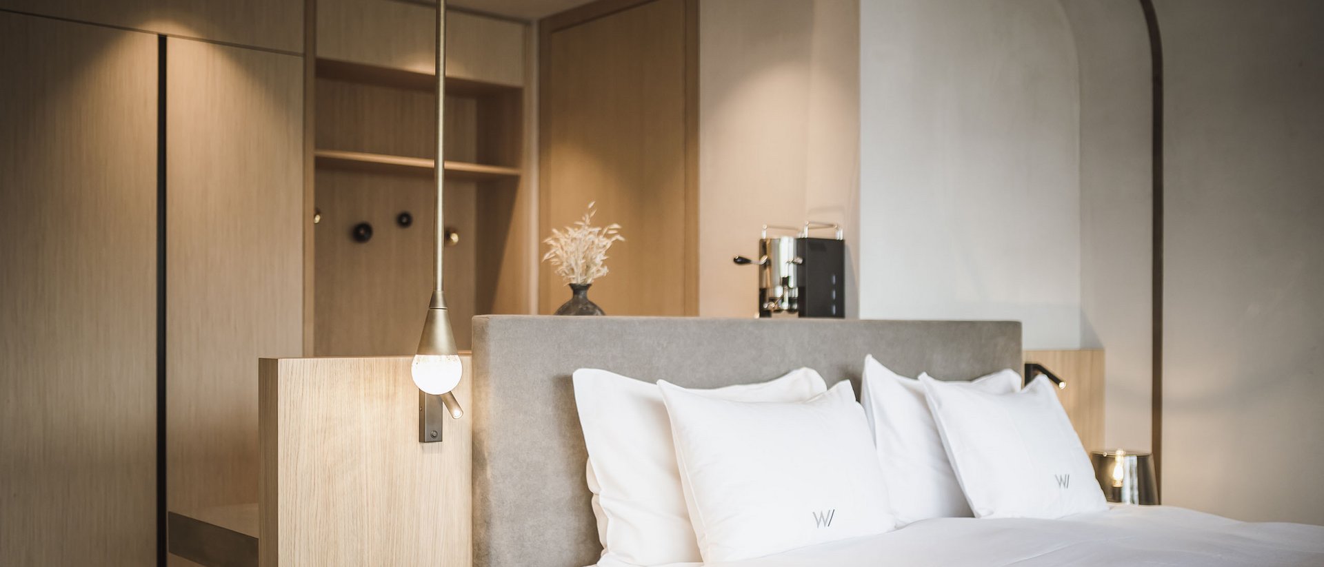 Modern hotel room with large bed and minimalist decor