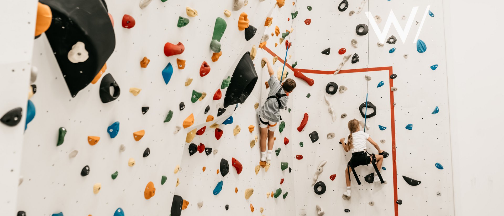 Your source of enrichment: our hotel at Mt Plan de Corones Children climbing a colorful indoor climbing wall