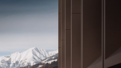 Building facade with snow-covered mountains in the background