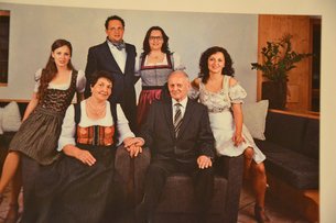 Family photo of six people, some wearing traditional costumes