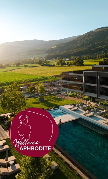 Your place to shine: our wellness hotel in South Tyrol Modern wellness area with outdoor pool and lounge chairs by green landscape