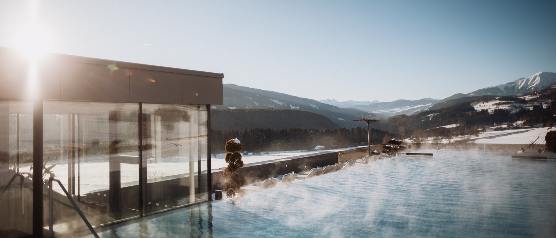 Hotel Solvie: a day spa in a class of its own Steaming outdoor pool with mountain view under clear sky and sunlight