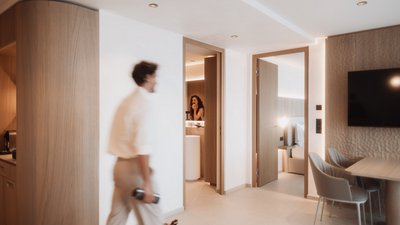 Photos from your hotel in Pfalzen in Val Pusteria/Pustertal Modern hotel room entry with view into bathroom and bedroom