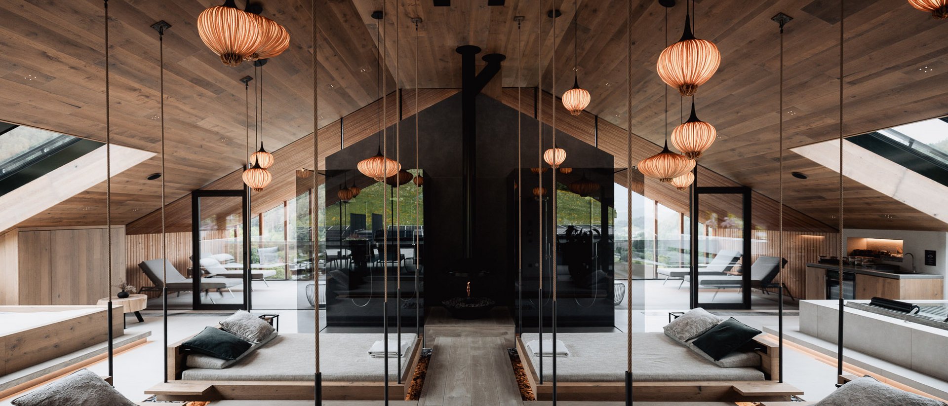 Modern spa with hanging beds, mirrors, and warm wooden accents