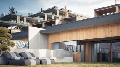 Costruzione moderna in legno con lettini su prato alla luce del giorno