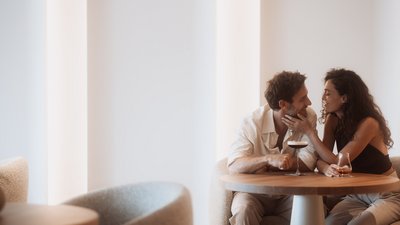 Photos from your hotel in Pfalzen in Val Pusteria/Pustertal Couple sharing an intimate moment over drinks at a cozy bar table