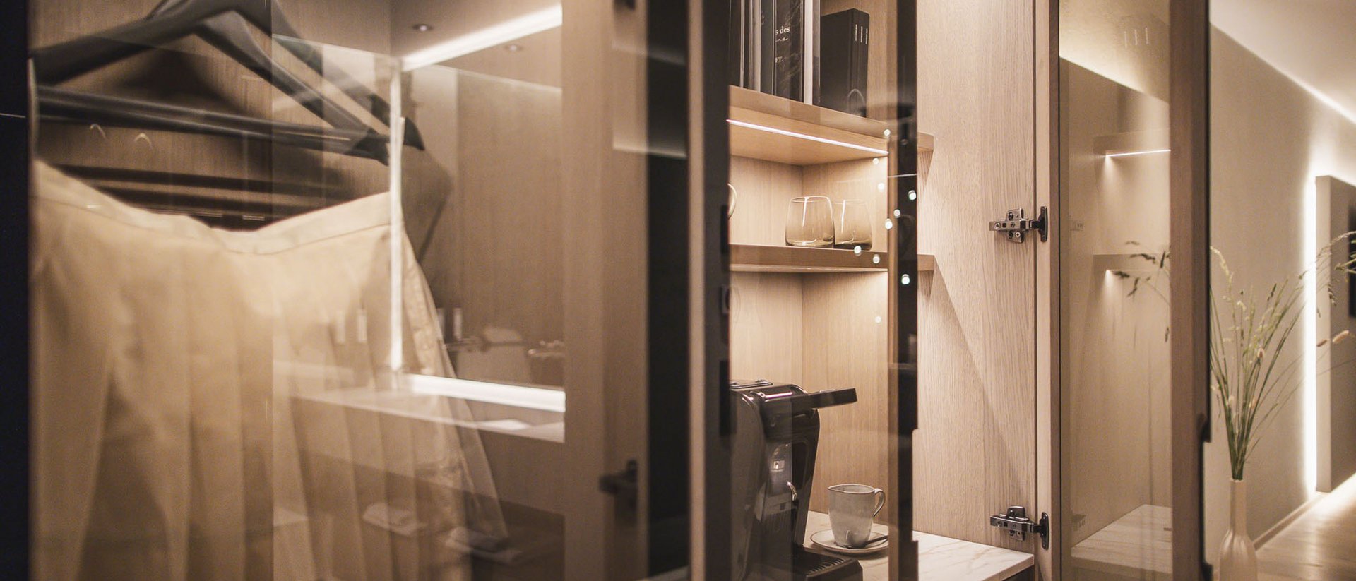 Moderner begehbarer Kleiderschrank mit Kleiderbügeln und Kaffeemaschine
