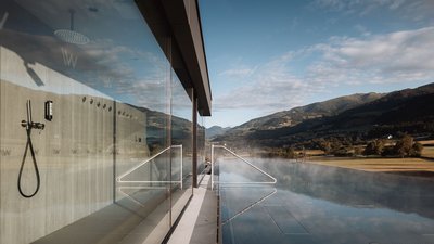Photos from your hotel in Pfalzen in Val Pusteria/Pustertal Outdoor heated pool with mountain view under clear sky