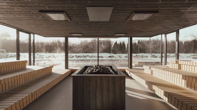 Photos from your hotel in Pfalzen in Val Pusteria/Pustertal Indoor sauna with wooden benches and view of snowy landscape
