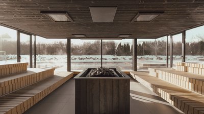 Photos from your hotel in Pfalzen in Val Pusteria/Pustertal Indoor sauna with wooden benches and view of snowy landscape