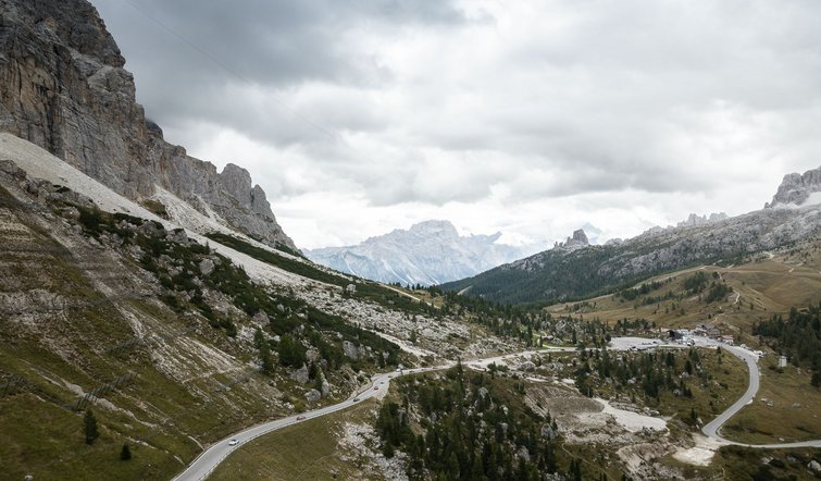 Winding mountain road under a cloudy sky