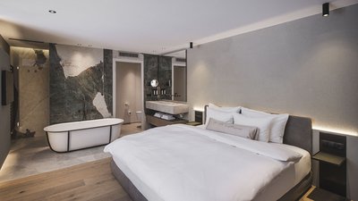 Modernes Hotelzimmer mit offenem Badezimmer und freistehender Badewanne