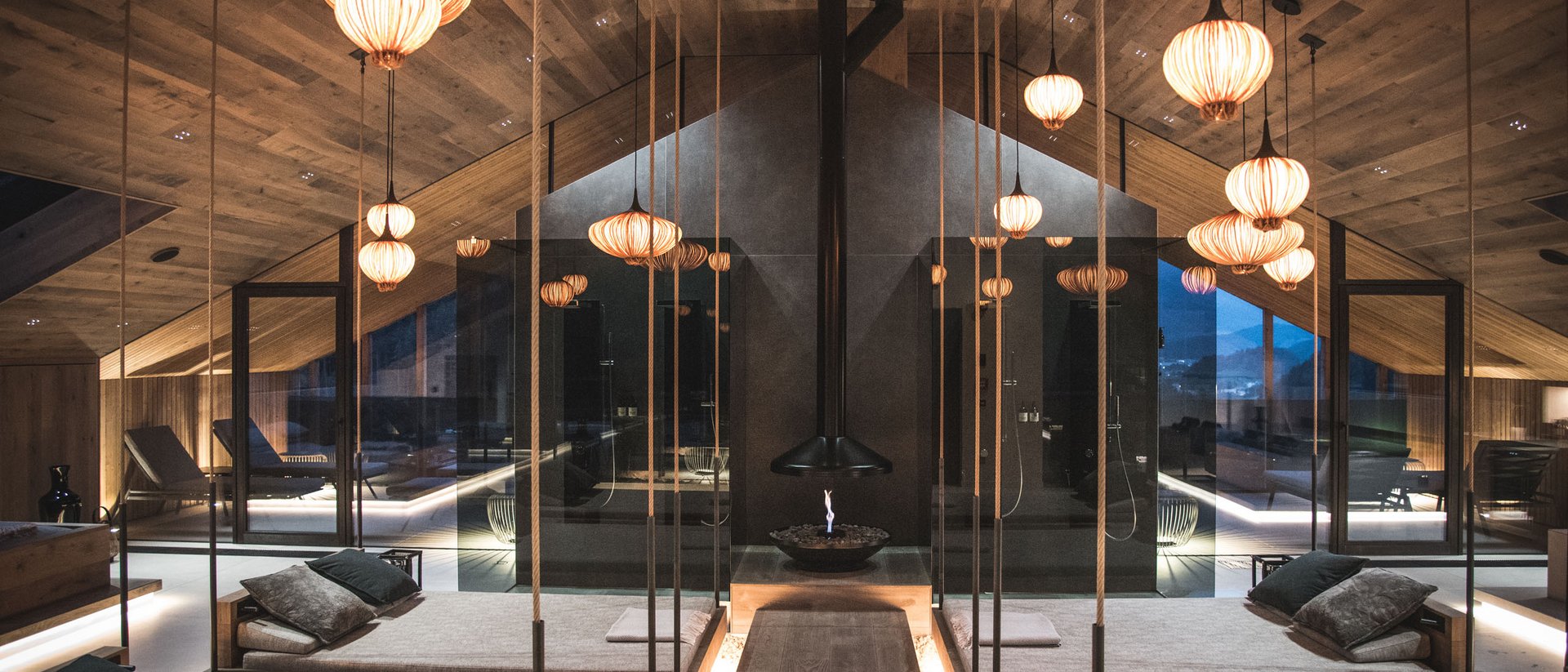 Spa moderno con lettini, pavimento in legno e luci calde