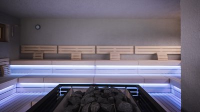 The best photos from our hotel in South Tyrol that kids love Modern sauna with illuminated wooden benches and stones in the heater