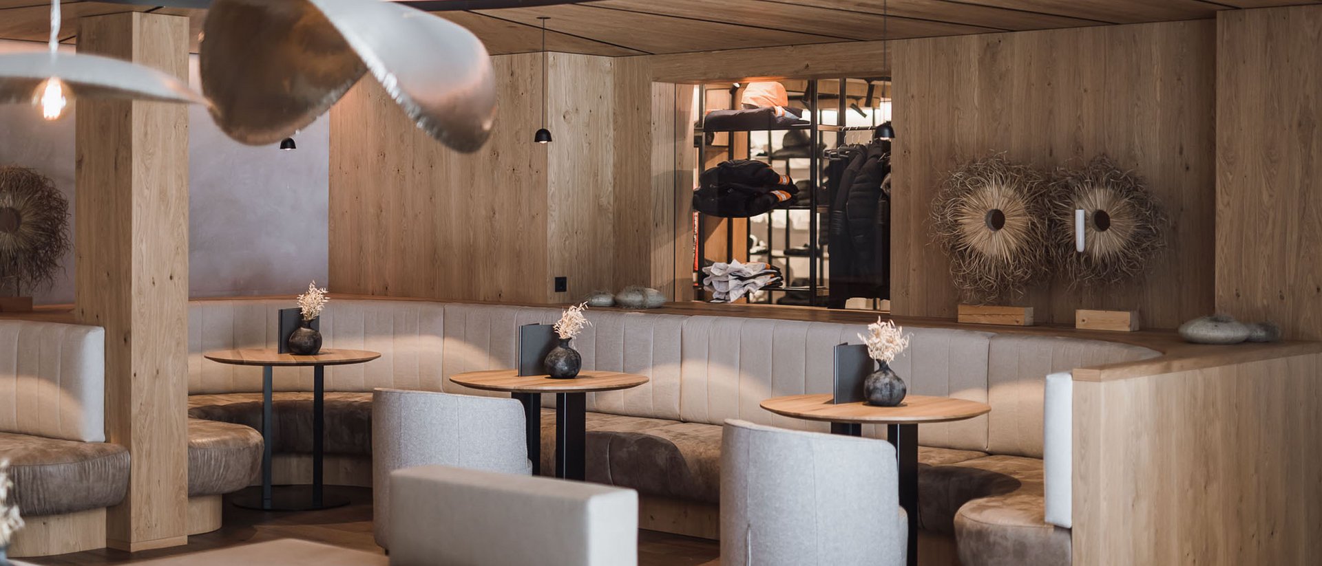 Your source of enrichment: our hotel at Mt Plan de Corones Modern cozy café with booths and wooden accents