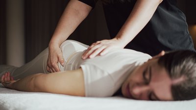 Photos from your hotel in Pfalzen in Val Pusteria/Pustertal Woman receiving back massage on massage table in calm room
