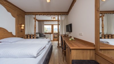The best photos from our hotel in South Tyrol that kids love Cozy hotel room with double bed, desk, and balcony view of mountains