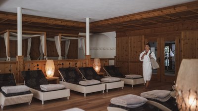The best photos from our hotel in South Tyrol that kids love Woman in bathrobe in a spa relaxation room with loungers and soft lighting