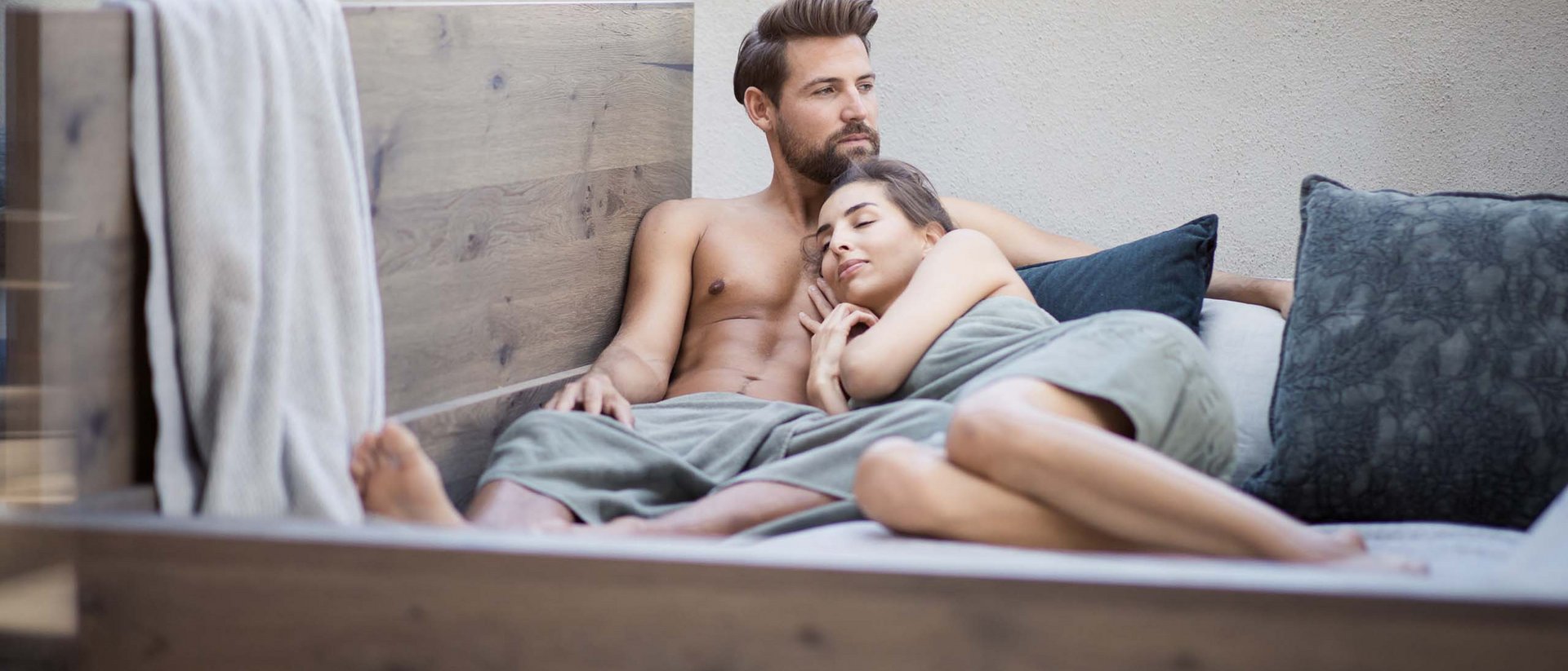An enriching holiday in your luxury chalet in South Tyrol Couple relaxing together on a sofa, woman leaning on man