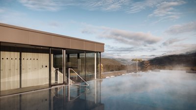 Photos from your hotel in Pfalzen in Val Pusteria/Pustertal Outdoor pool with mist and mountain view under clear sky