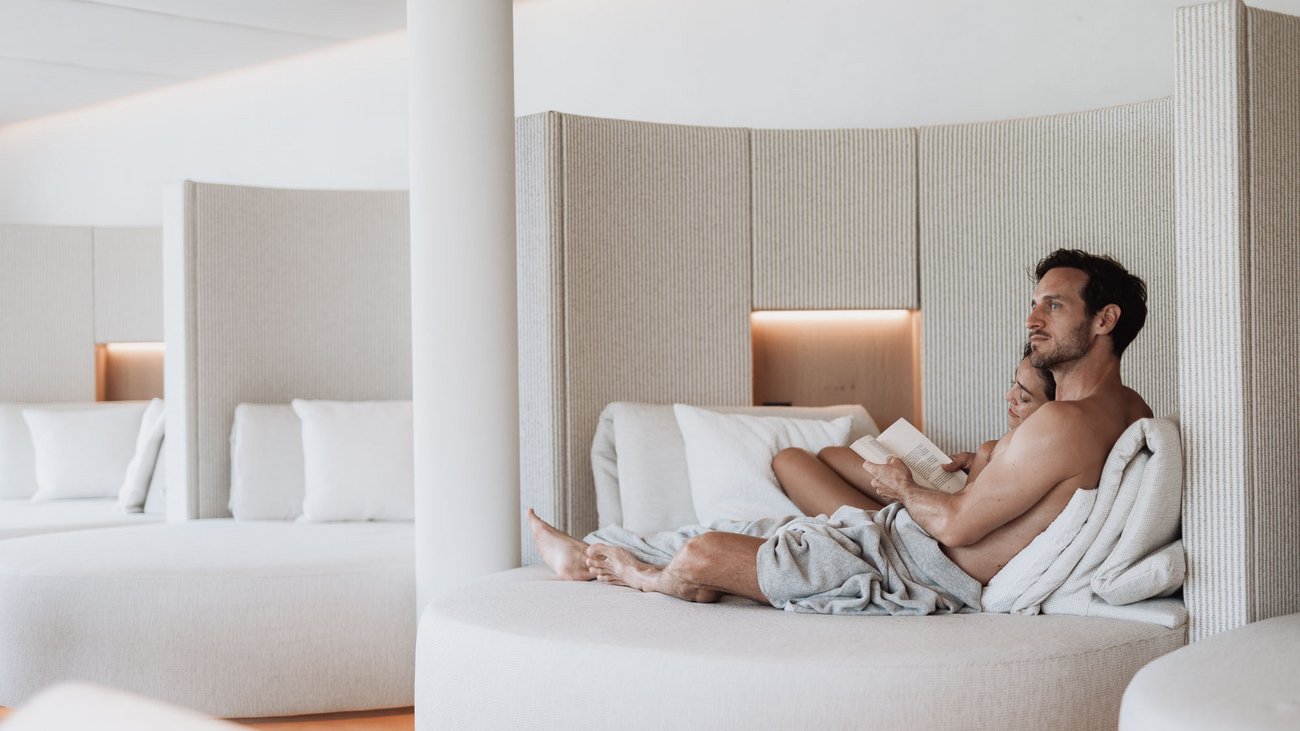Couple relaxing on a modern round lounge sofa