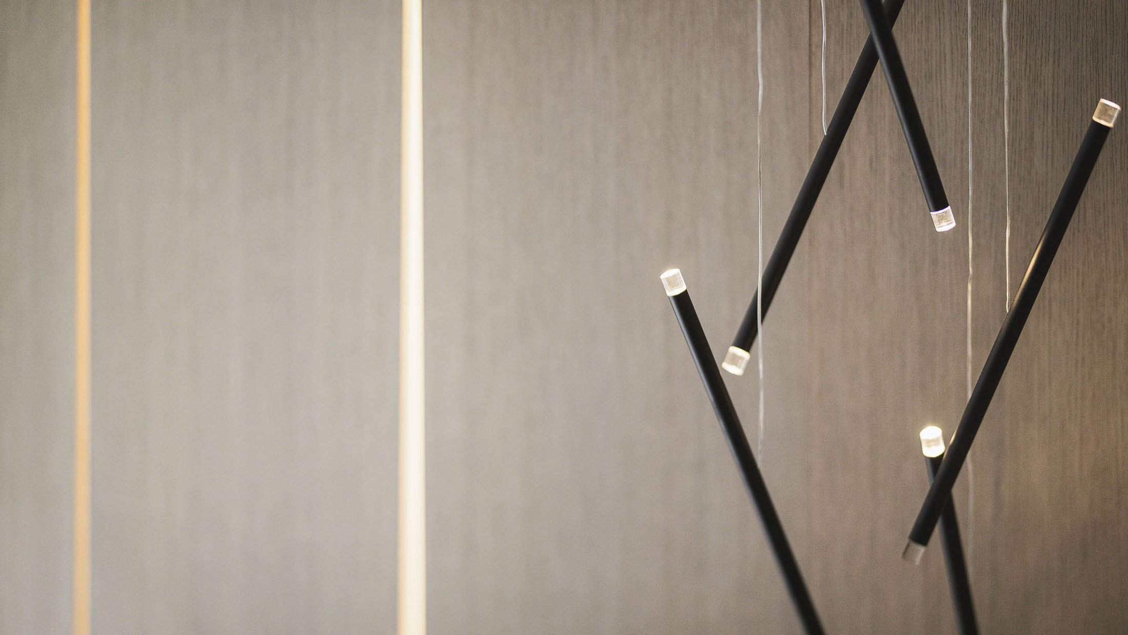 Lampade a sospensione nere moderne davanti a parete grigia