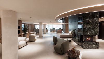 Modern hotel lobby with fireplace and rounded furniture